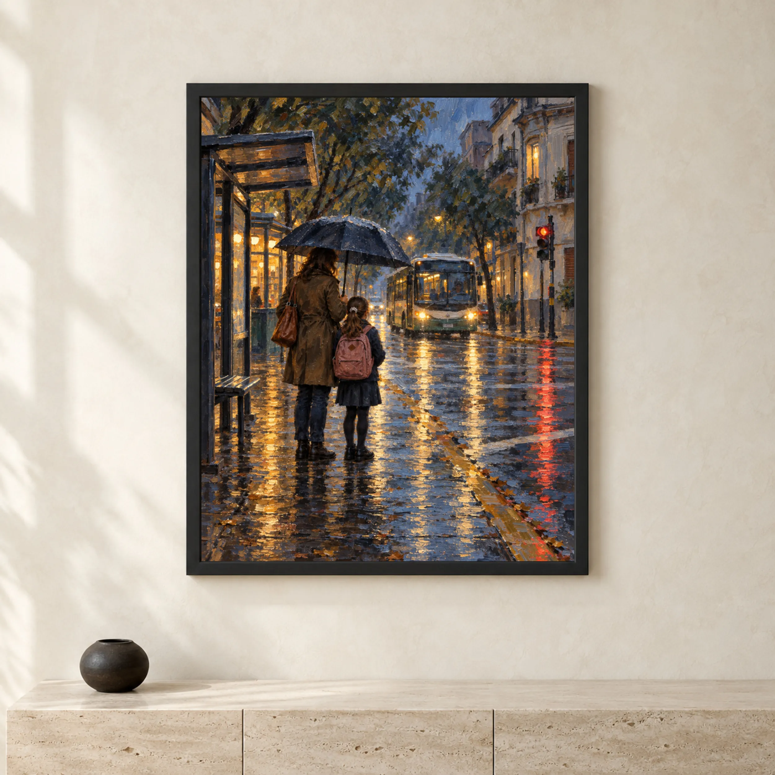 Framed print of a mother and daughter under an umbrella waiting for a bus on a rainy street hanging in a warm interior.
